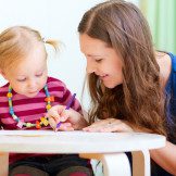 A woman and child are sitting at the table