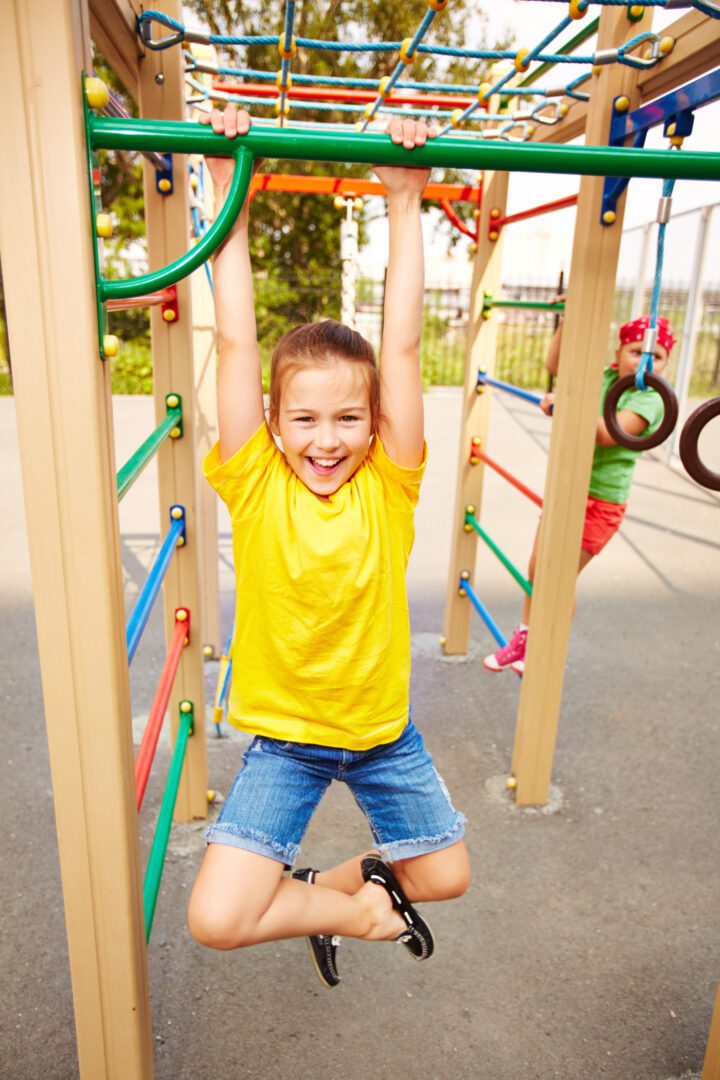 A young boy is playing on the playground.