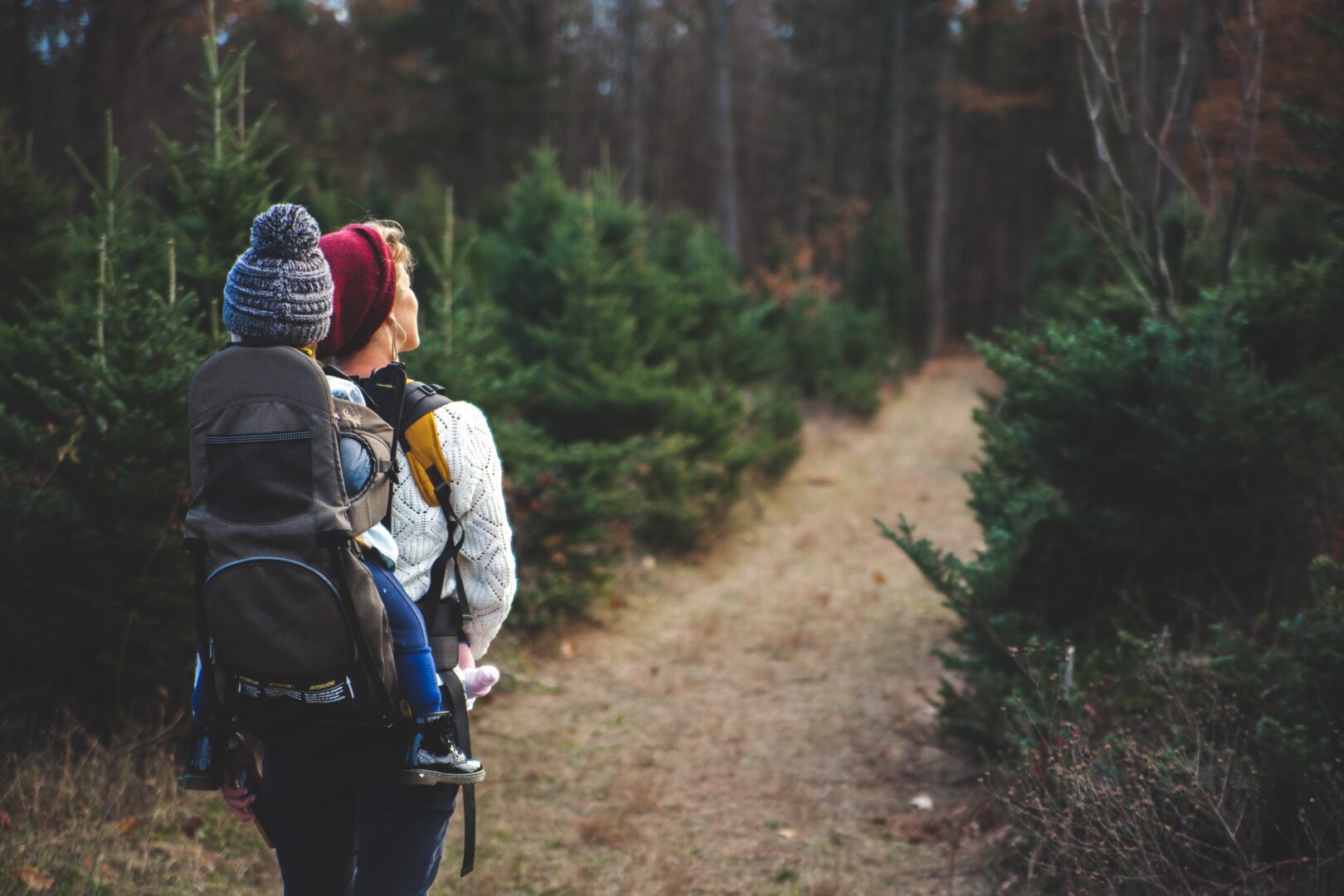A woman and child walking in the woods